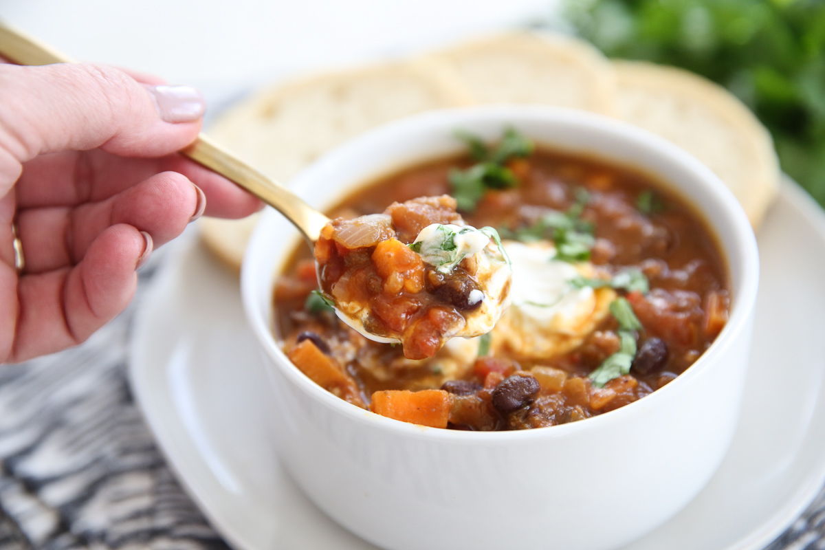 turkey sweet potato chili in a bowl with bread on the side