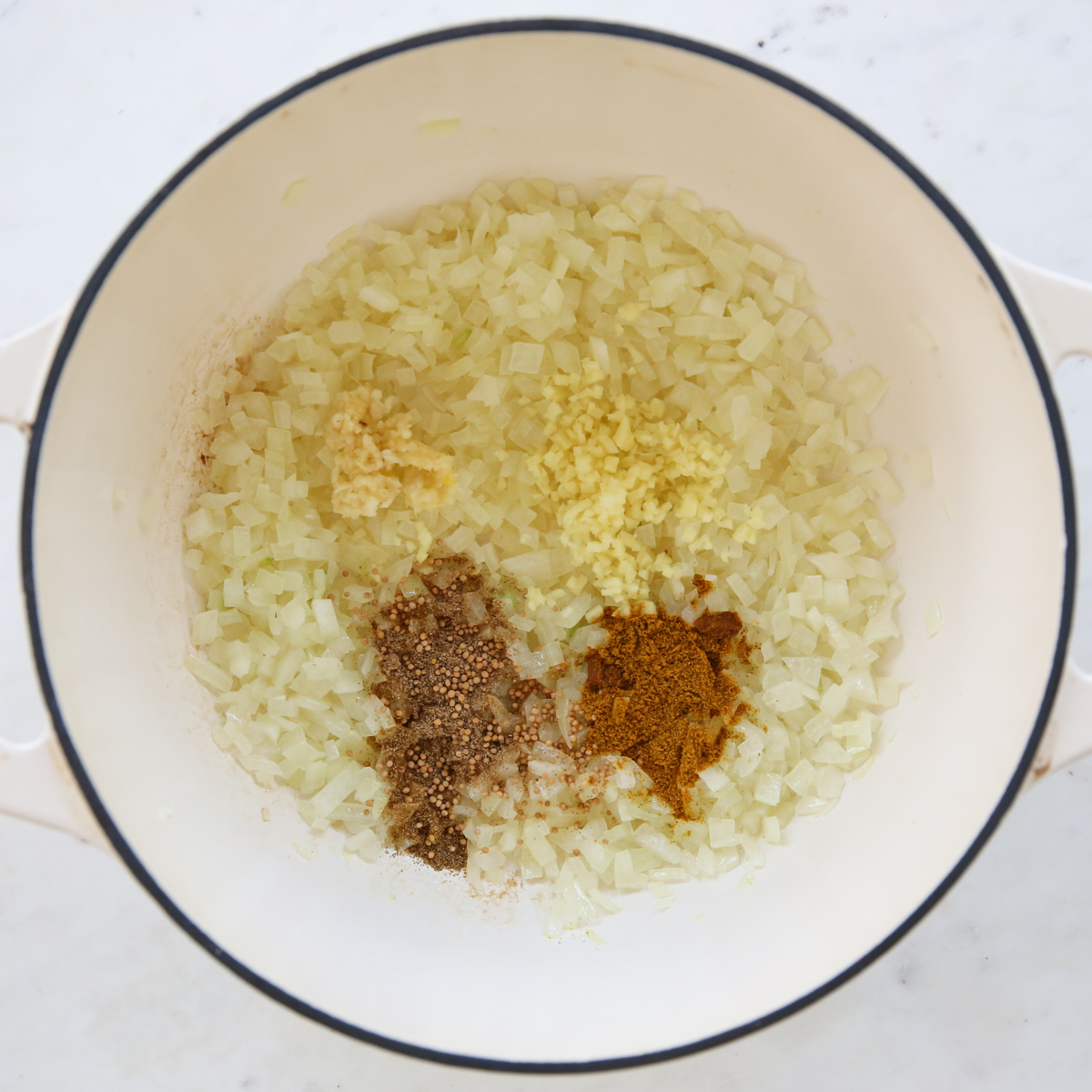 onions and seasonings in a white pot