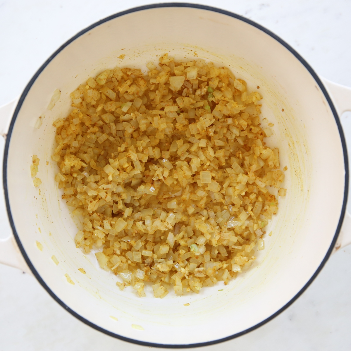 sauteed onions in a large white pot