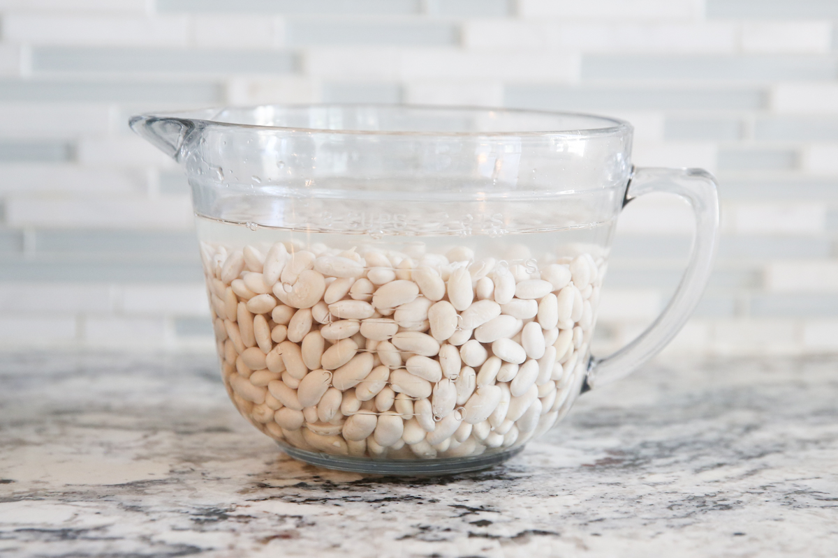 white beans soaking in water