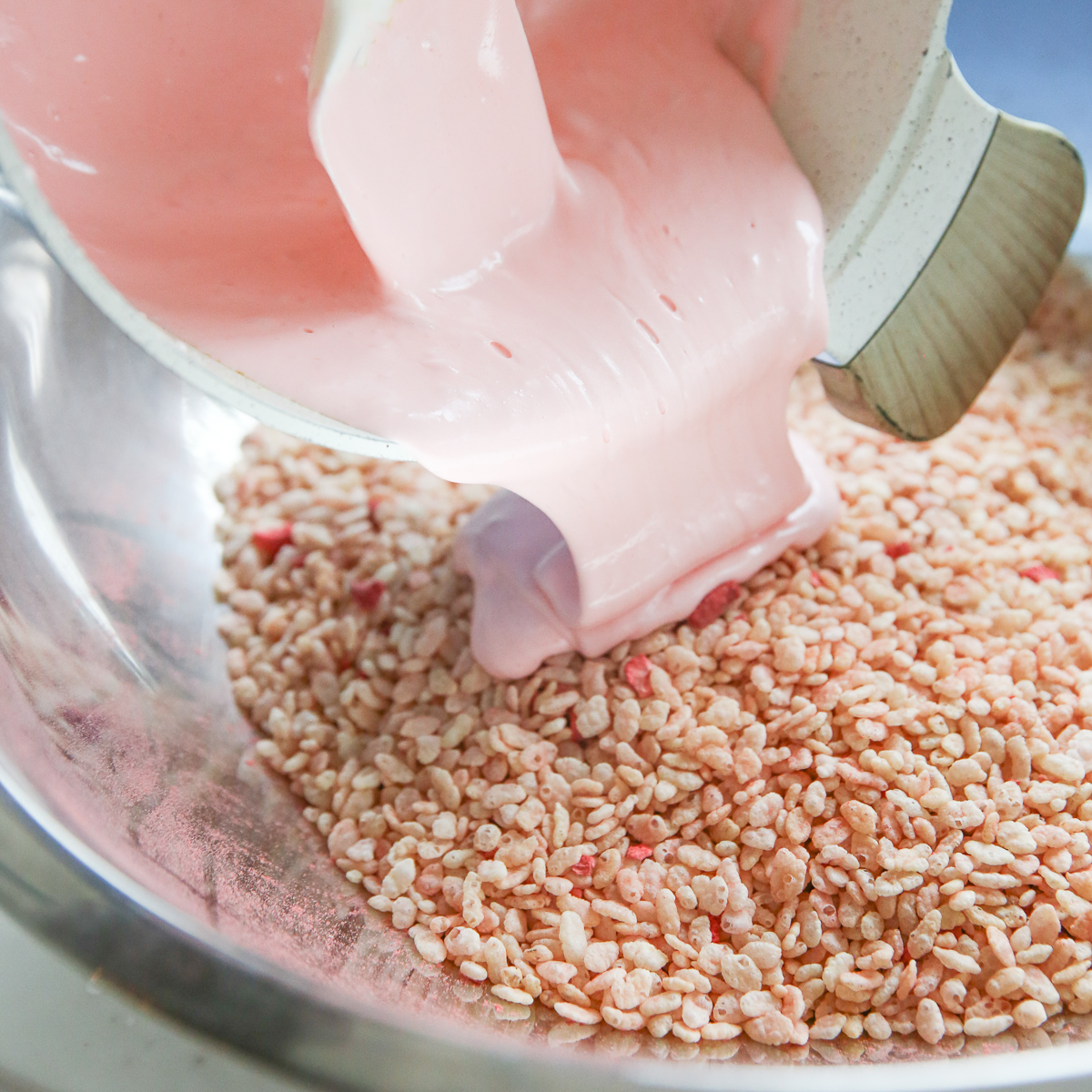 pouring melted marshmallows over cereal in a bowl