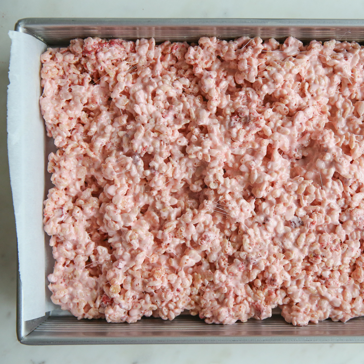 pink strawberry rice krispie treats in a pan