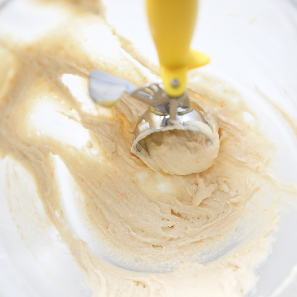 cookie scoop, scooping orange buttermilk donuts