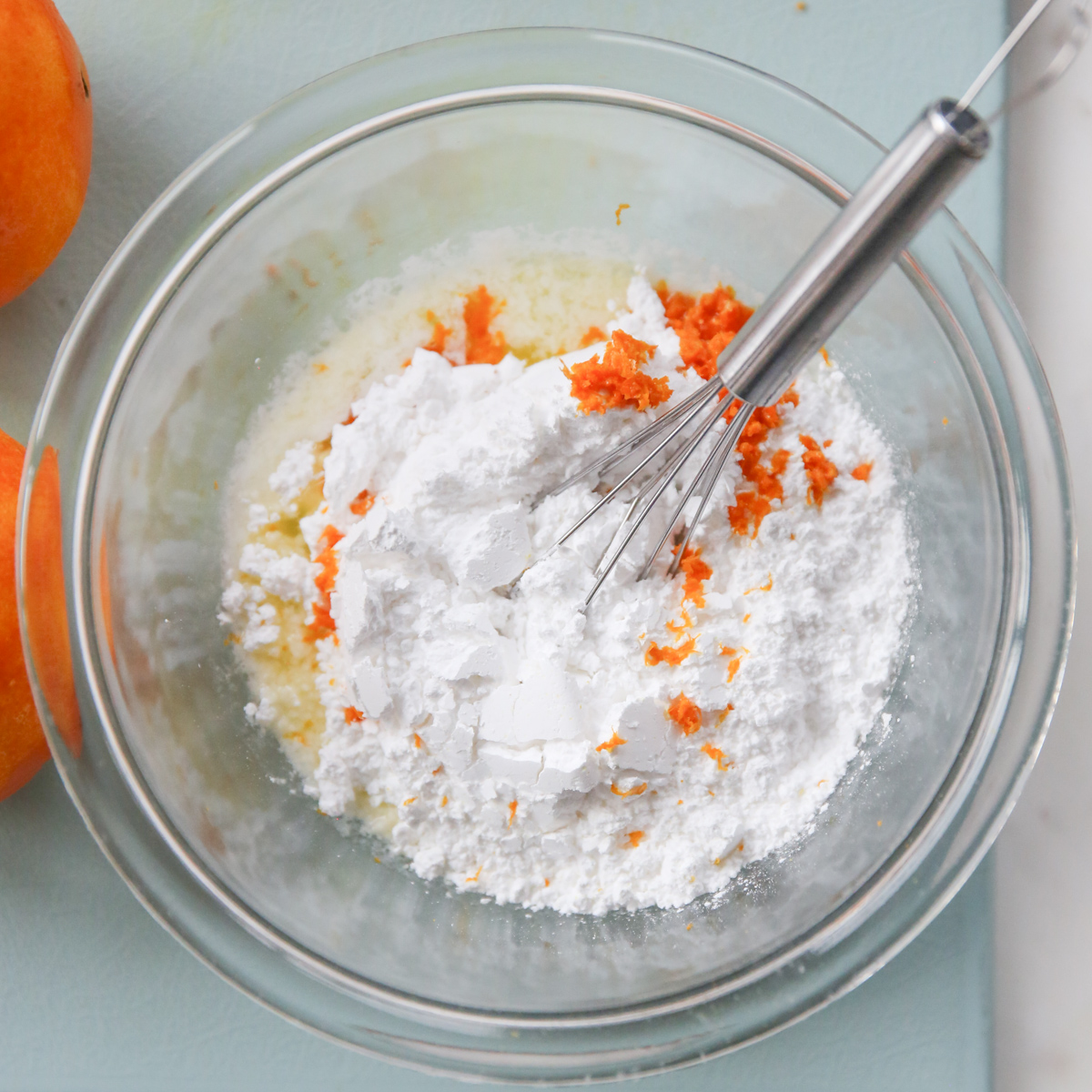 powdered sugar in a bowl with fresh orange zest