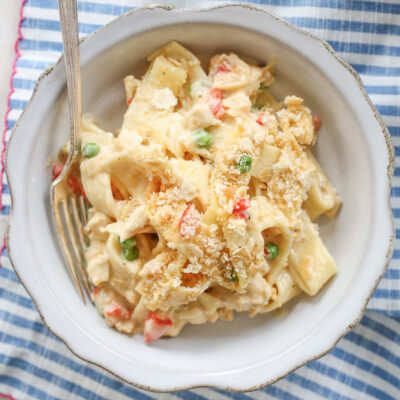 creamy chicken noodle casserole in a bowl with a silver fork