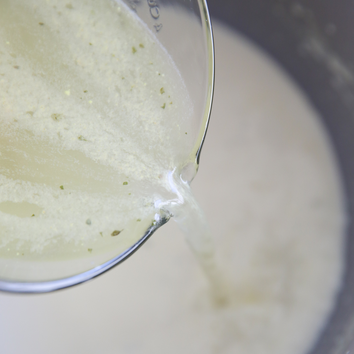 pouring broth into a stock pot
