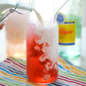 pouring cream into an Italian soda