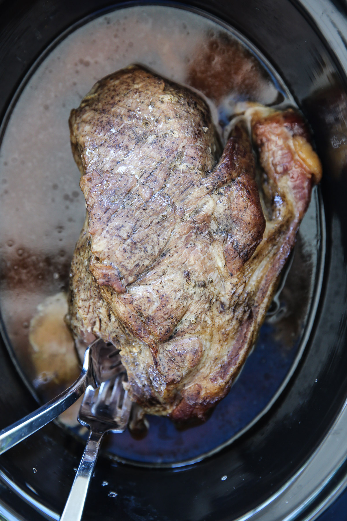 cooked pork roast in a slow cooker