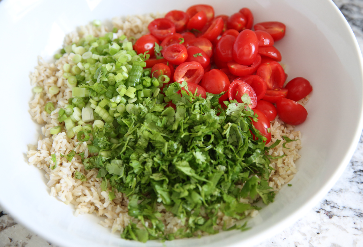 brown rice salad ingredients in a white bowl
