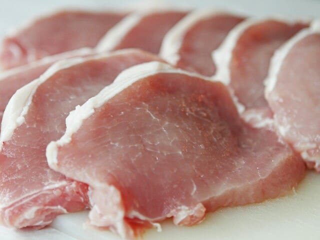 Baked pork chops in creamy Brie and mushroom sauce from Our Best Bites