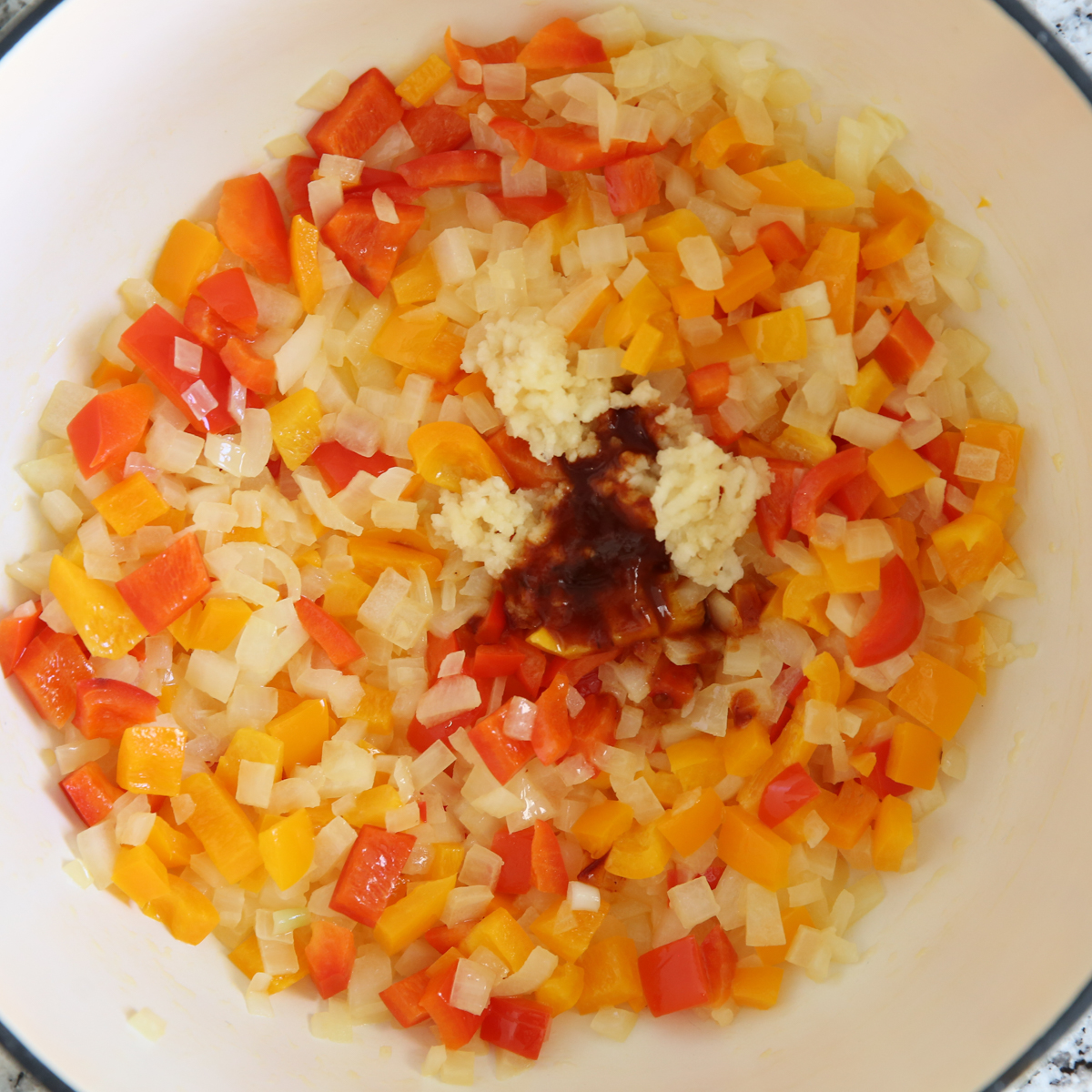 chopped veggies in a soup pot with chipotle powder
