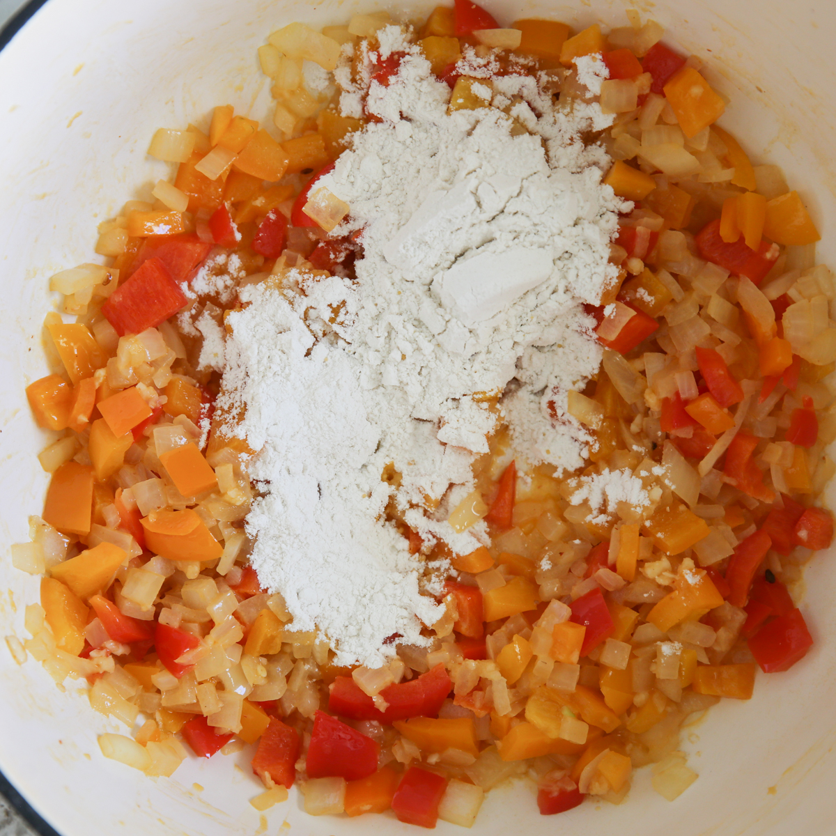 chopped veggies in a soup pot with flour