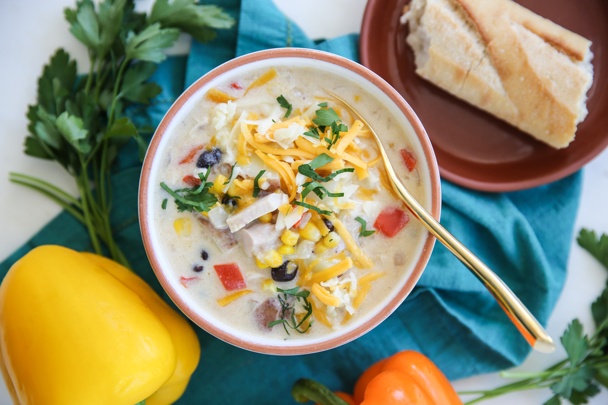 creamy chicken soup in a bowl with mexican toppings