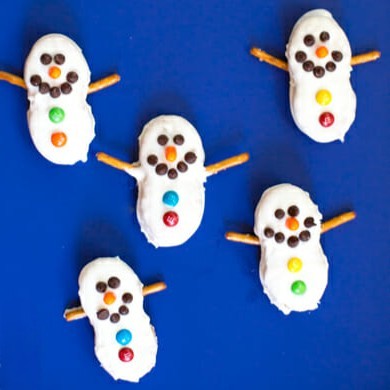 Snowmen made out of nutter butter cookies, dipped in almond bark, and decorated with mini M&Ms and pretzels.