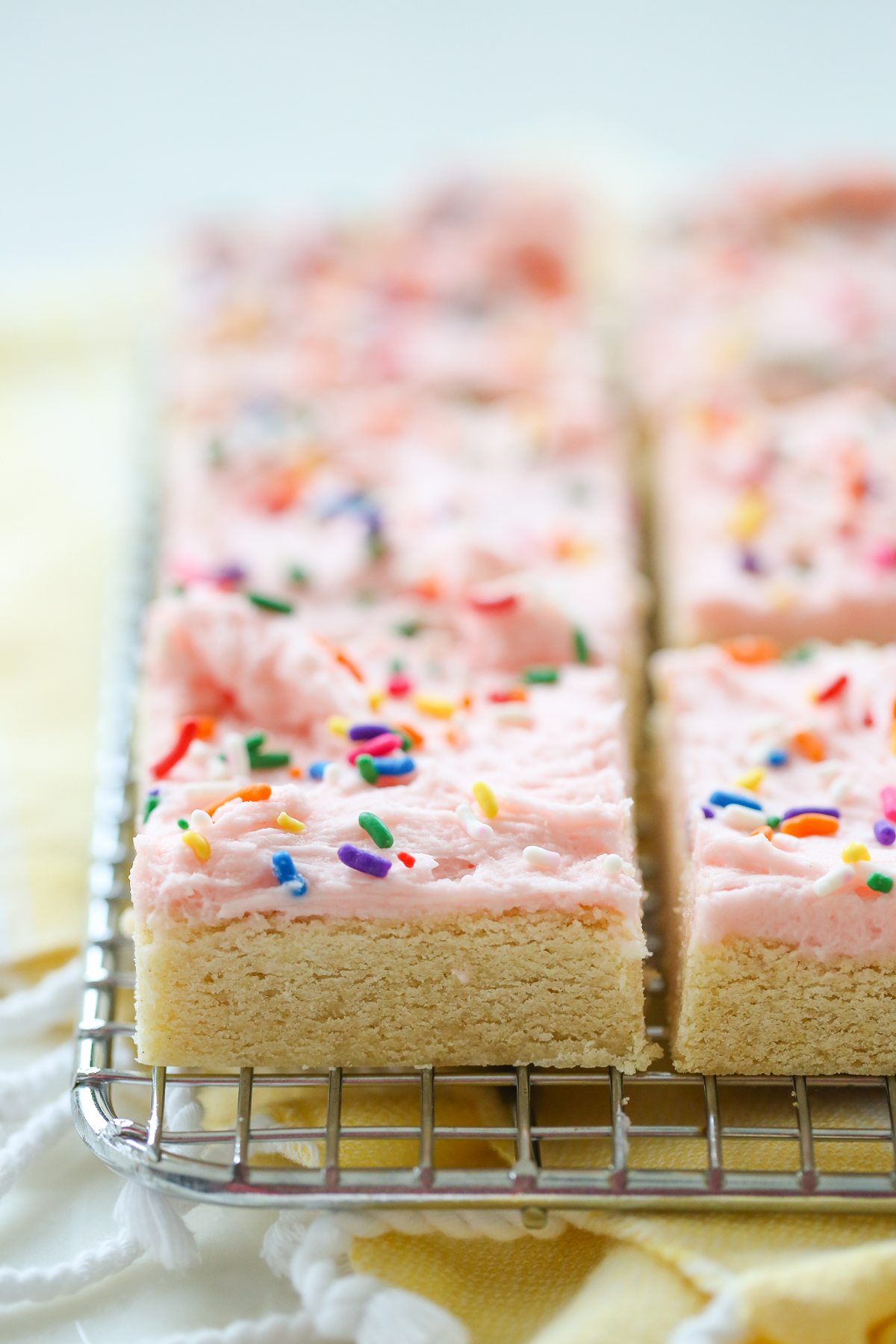 Close up of pink frosted sugar cookie bars