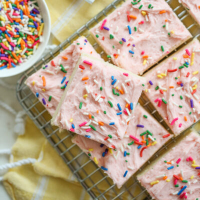 frosted sugar cookie bars on a rack with sprinkles