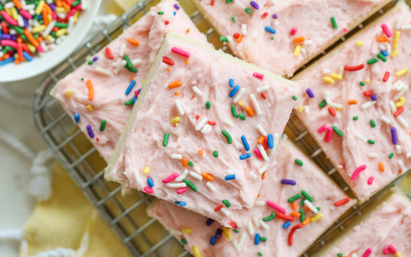 frosted sugar cookie bars on a rack with sprinkles