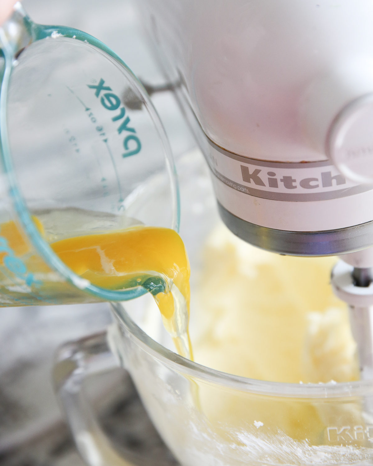 adding eggs to sugar cookie dough