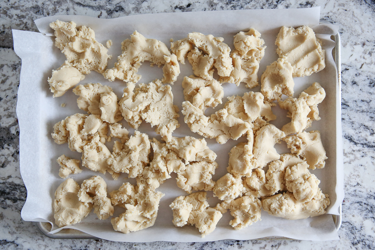 sugar cookie dough dropped onto baking sheet
