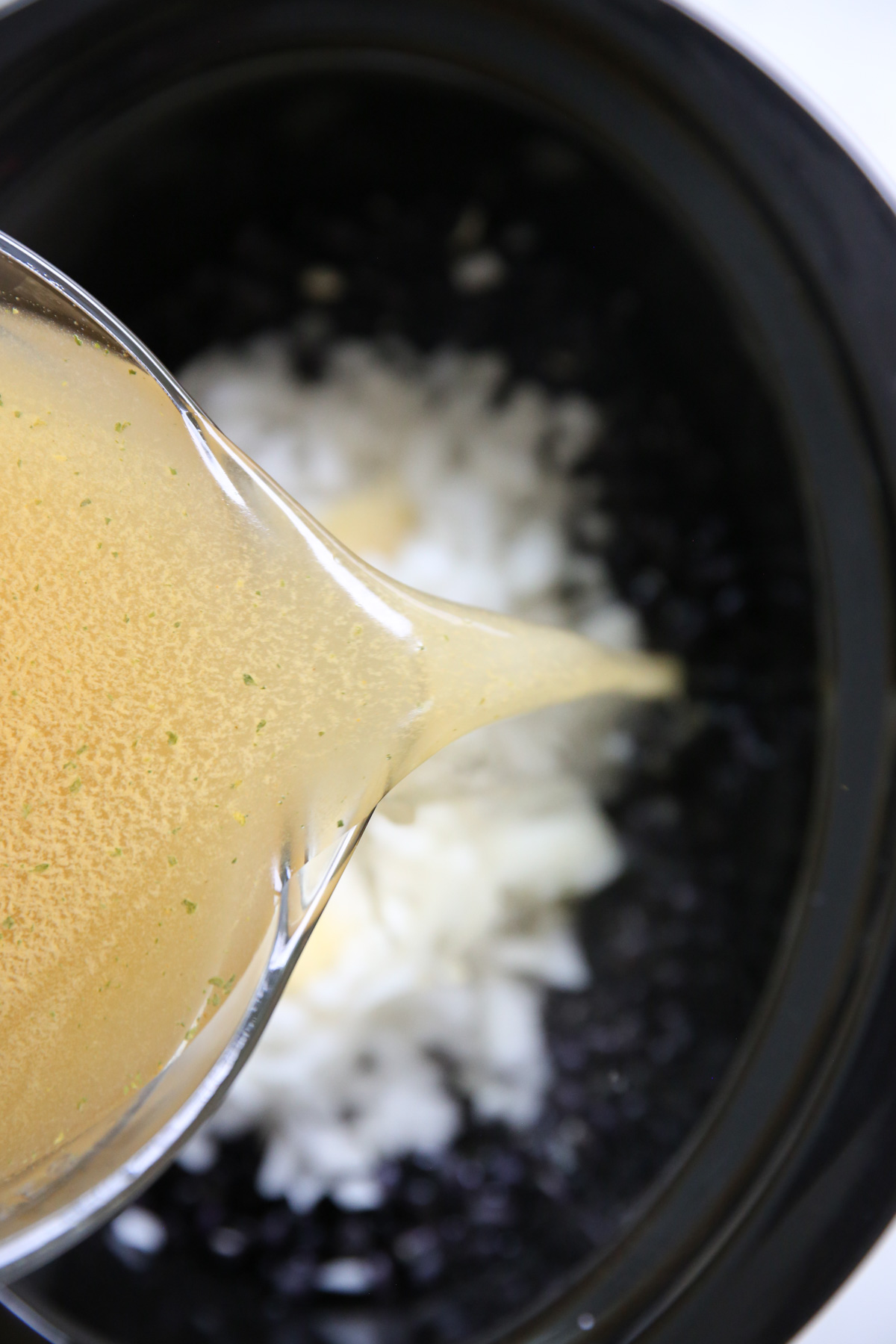 pouring broth into slow cooker