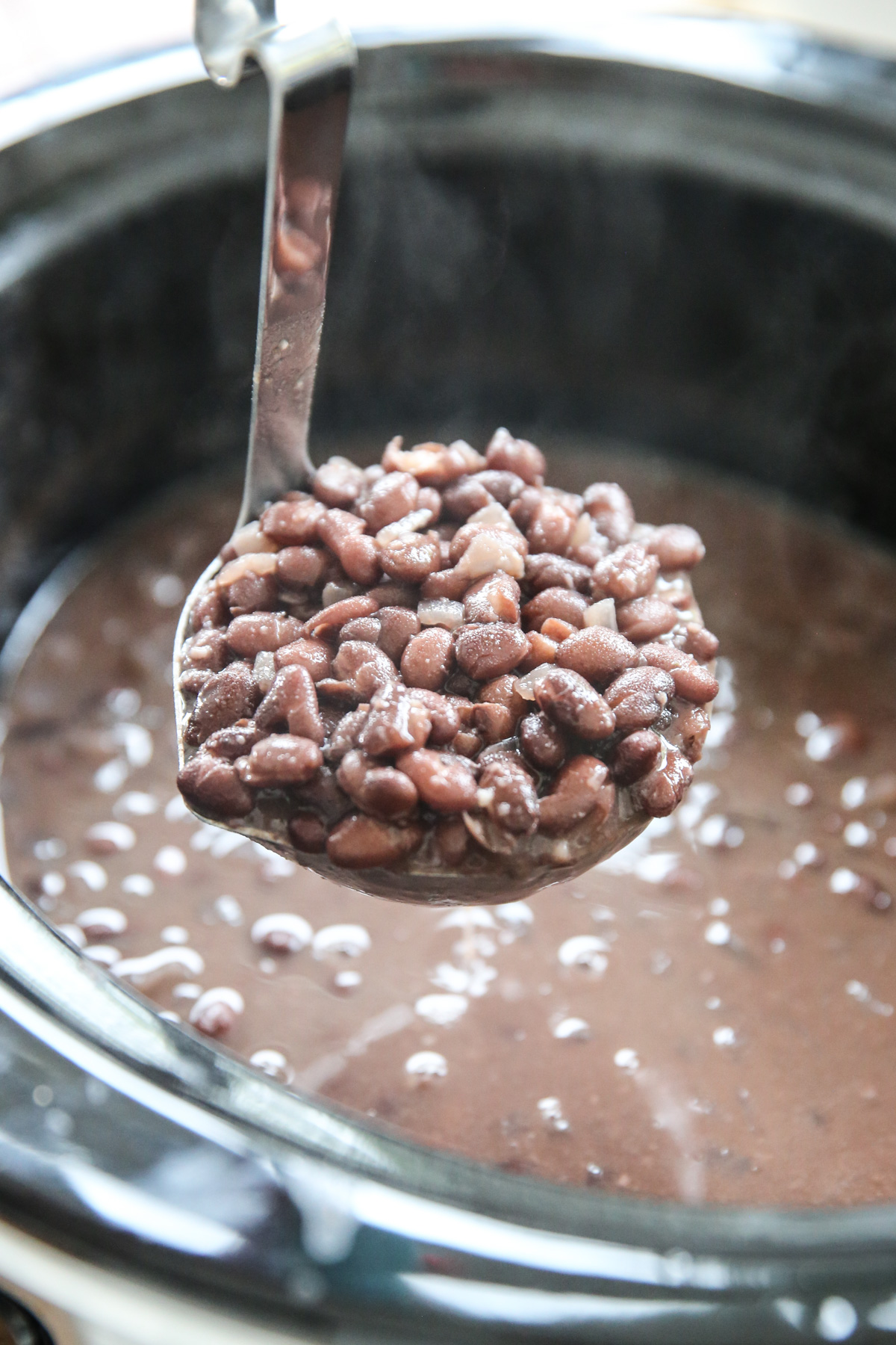 Ladle of cooked black beans