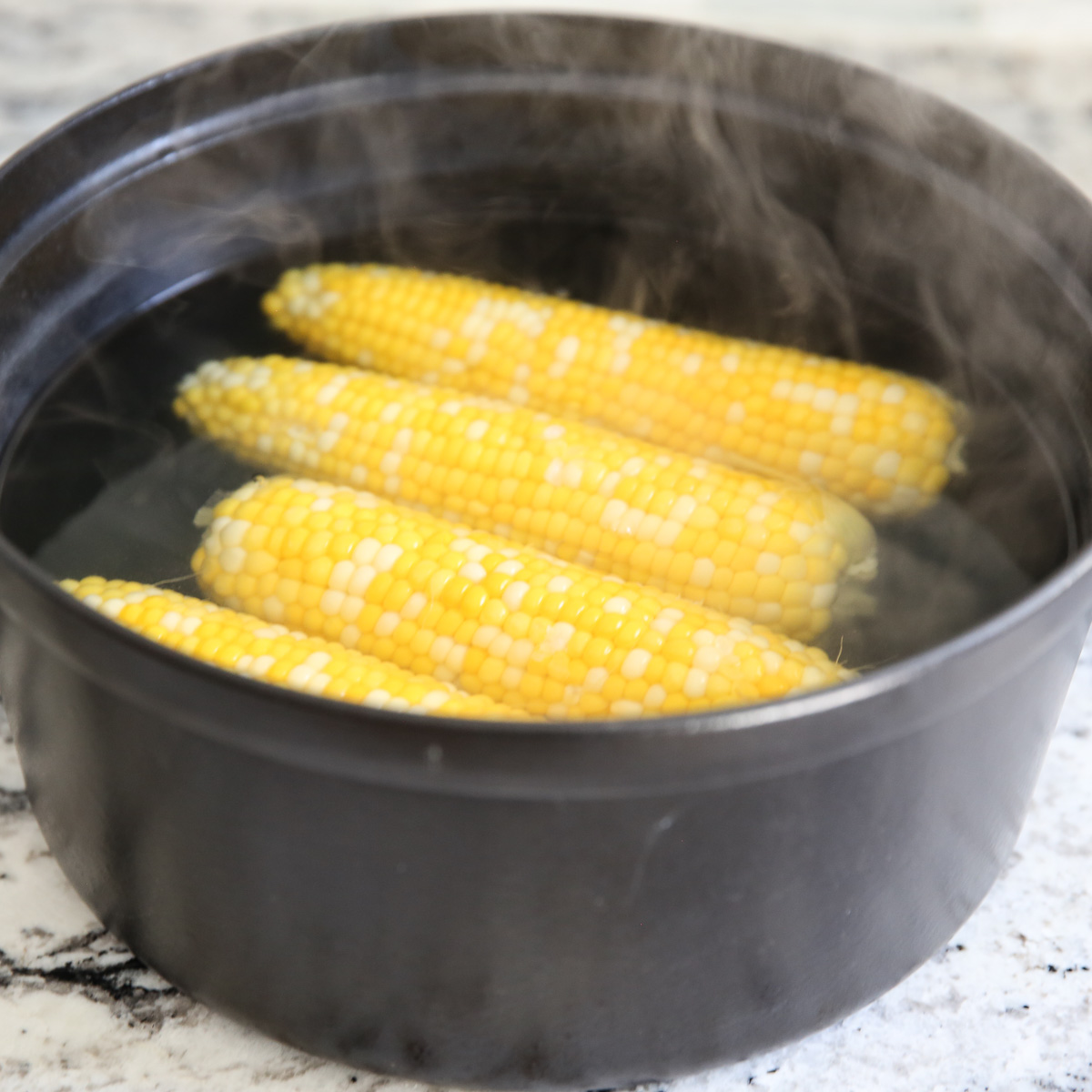 corn in a black pot of water