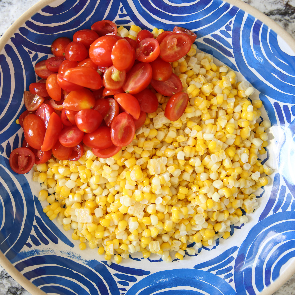 Fresh corn salad in a blue bowl