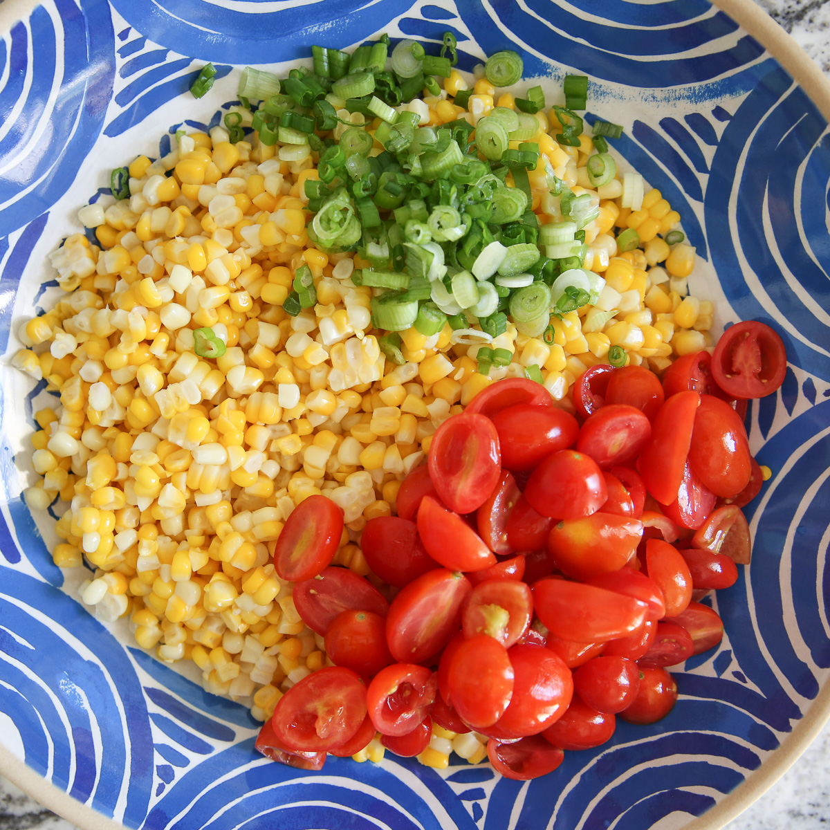 Fresh corn salad in a blue bowl