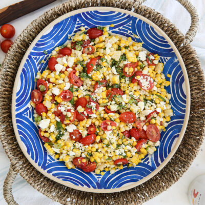 Fresh corn salad in a blue bowl