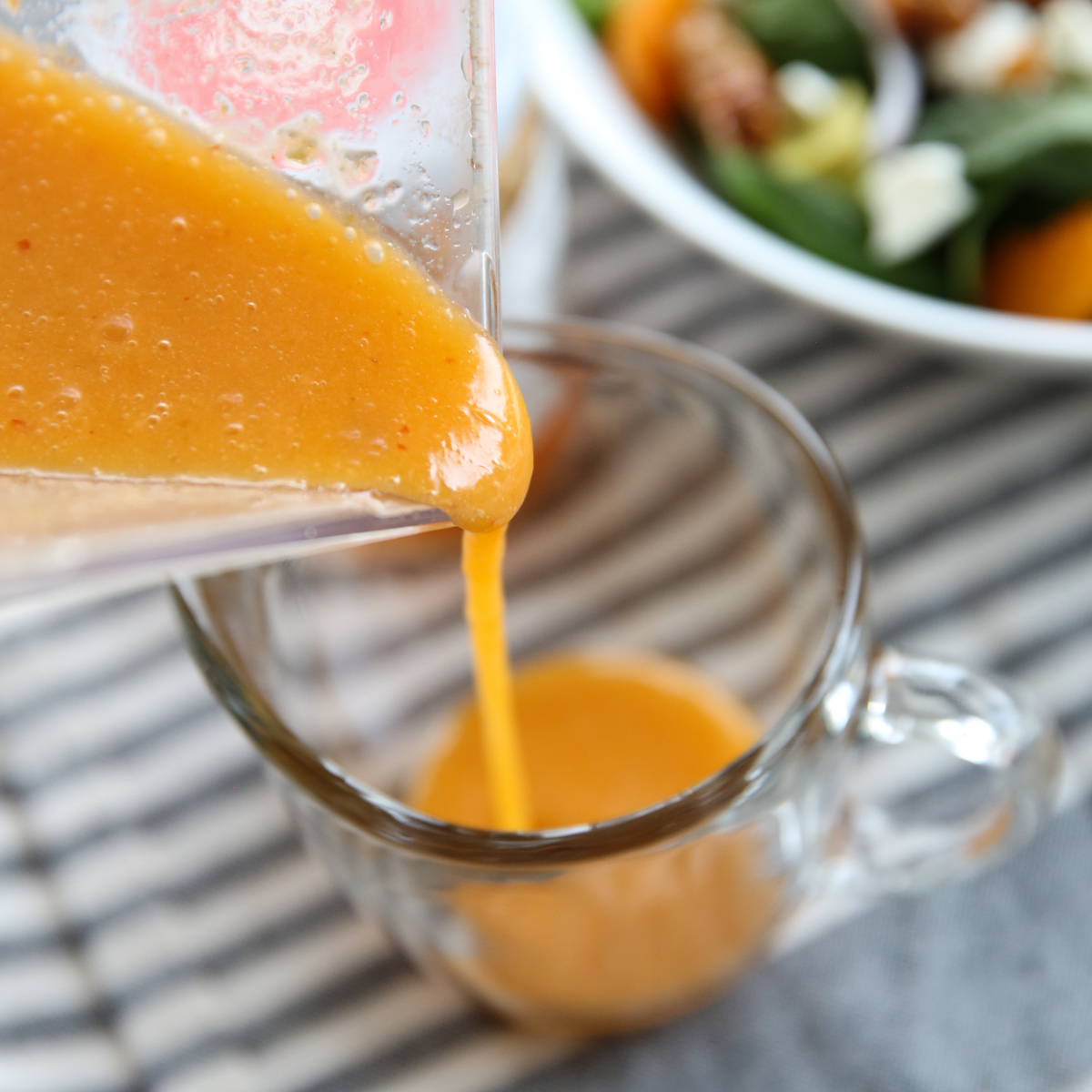 pouring vinaigrette into a jar