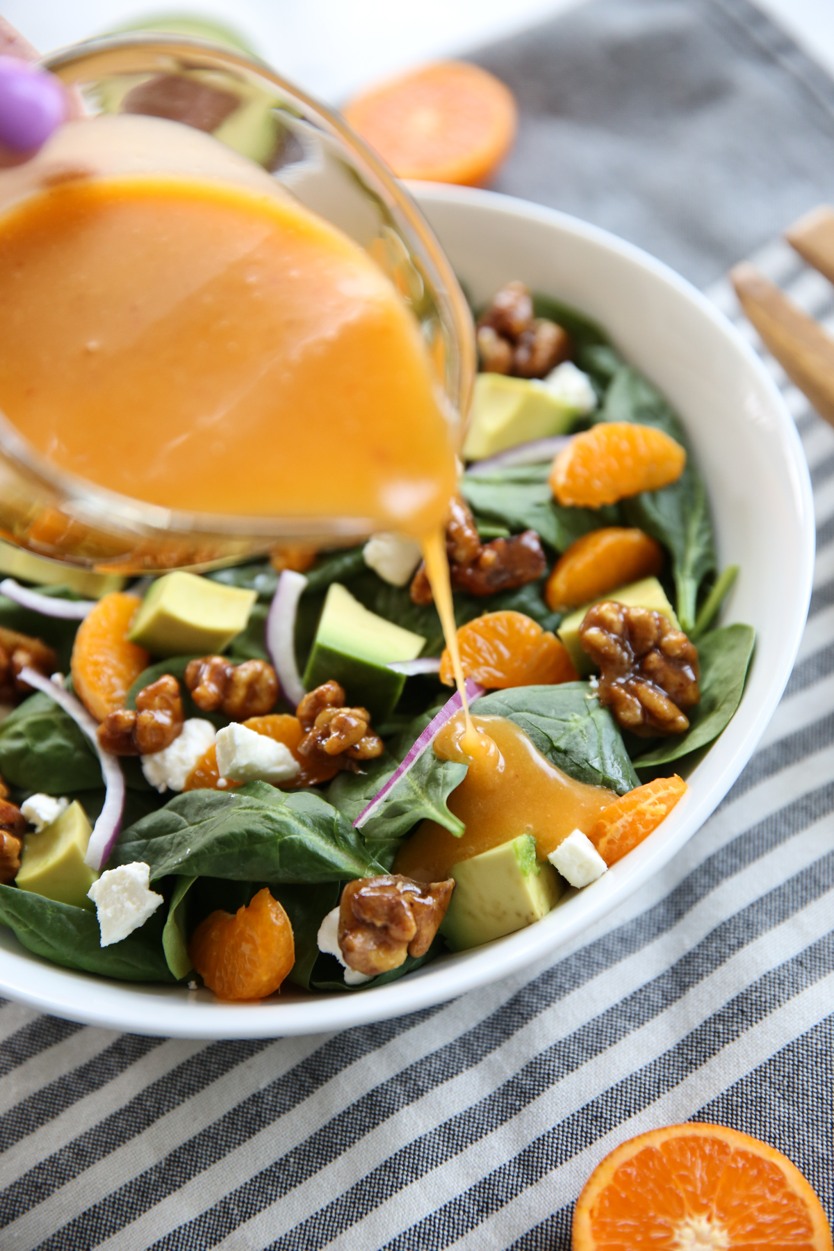 pouring dressing over a salad