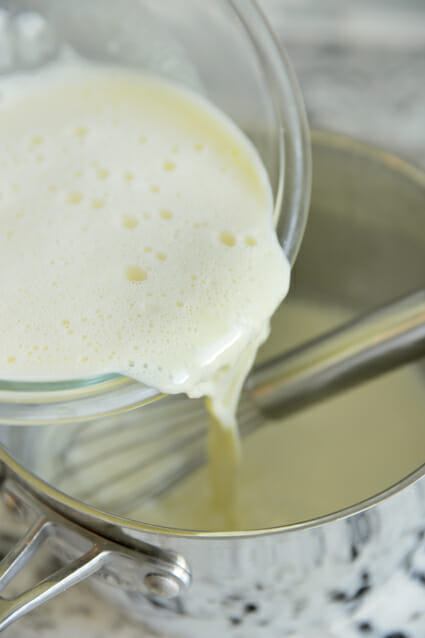 adding tempered eggs into custard