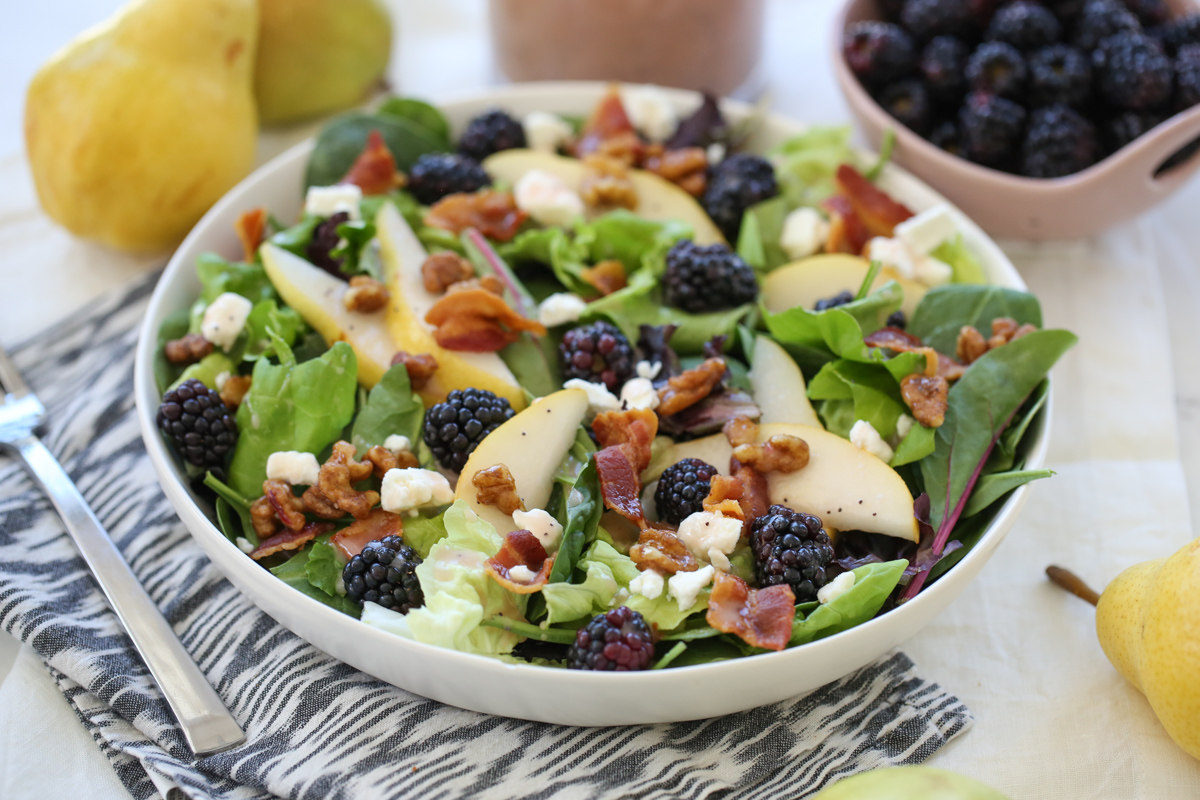 blackberry pear salad in a white bowl