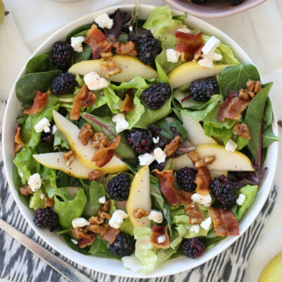 blackberry pear salad in a white bowl