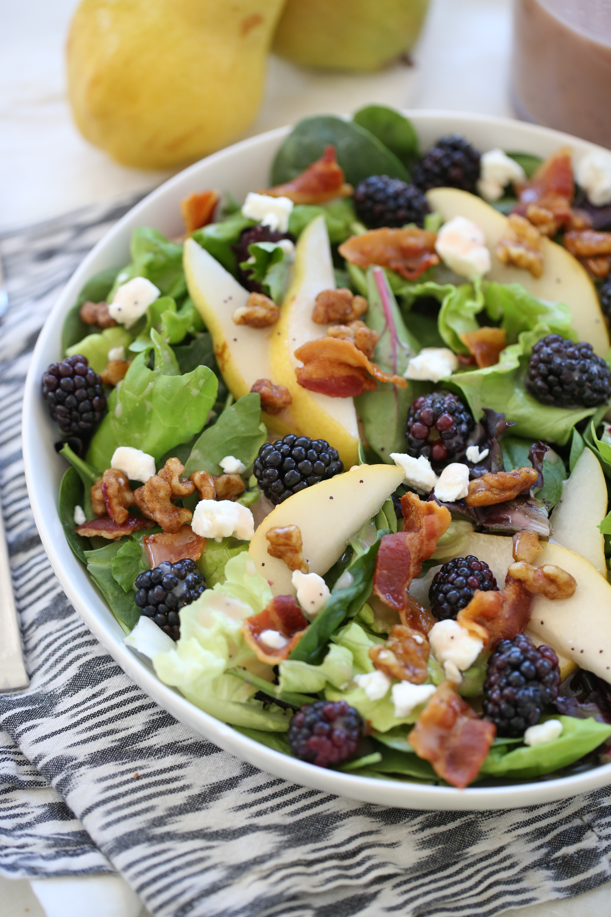 blackberry pear salad in a white bowl