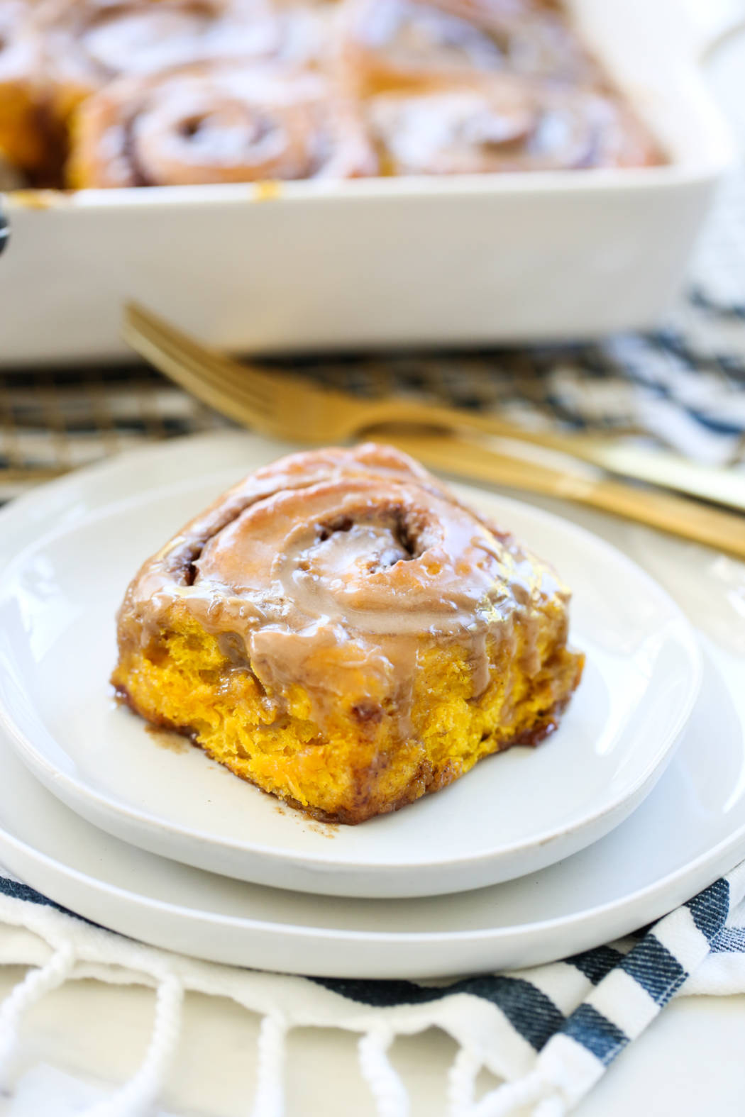 Pumpkin Spice Cinnamon Roll on a white plate