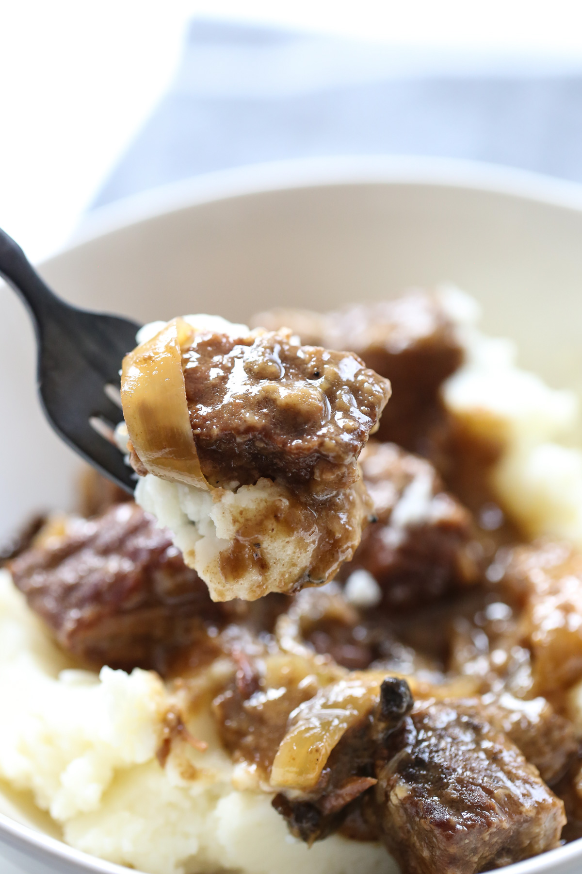 Beef and onions on a fork