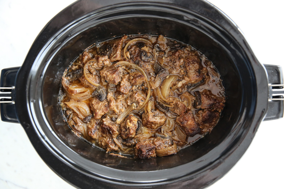 beef and onions in a slowcooker after cooking
