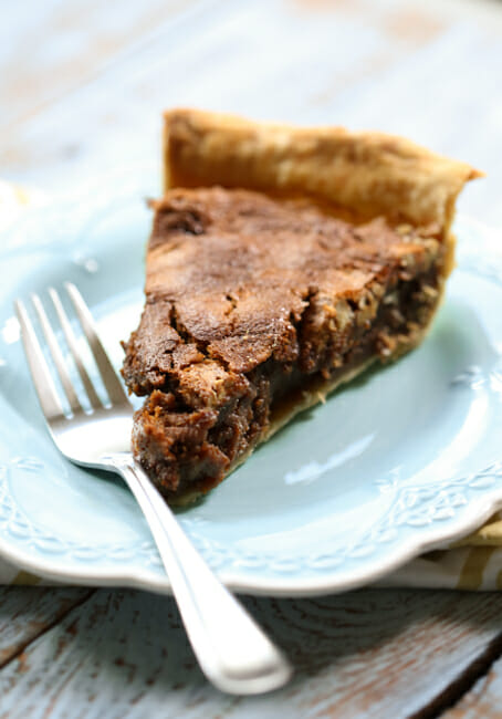 slice of caramel chocolate pecan pie on a plate