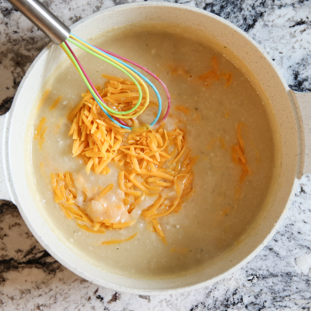 shredded cheddar cheese in sauce