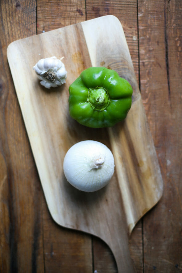 bell pepper, garlic and onion on a cutting board
