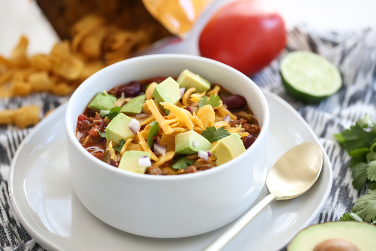 Easy Weeknight Chili in a white bowl with toppings
