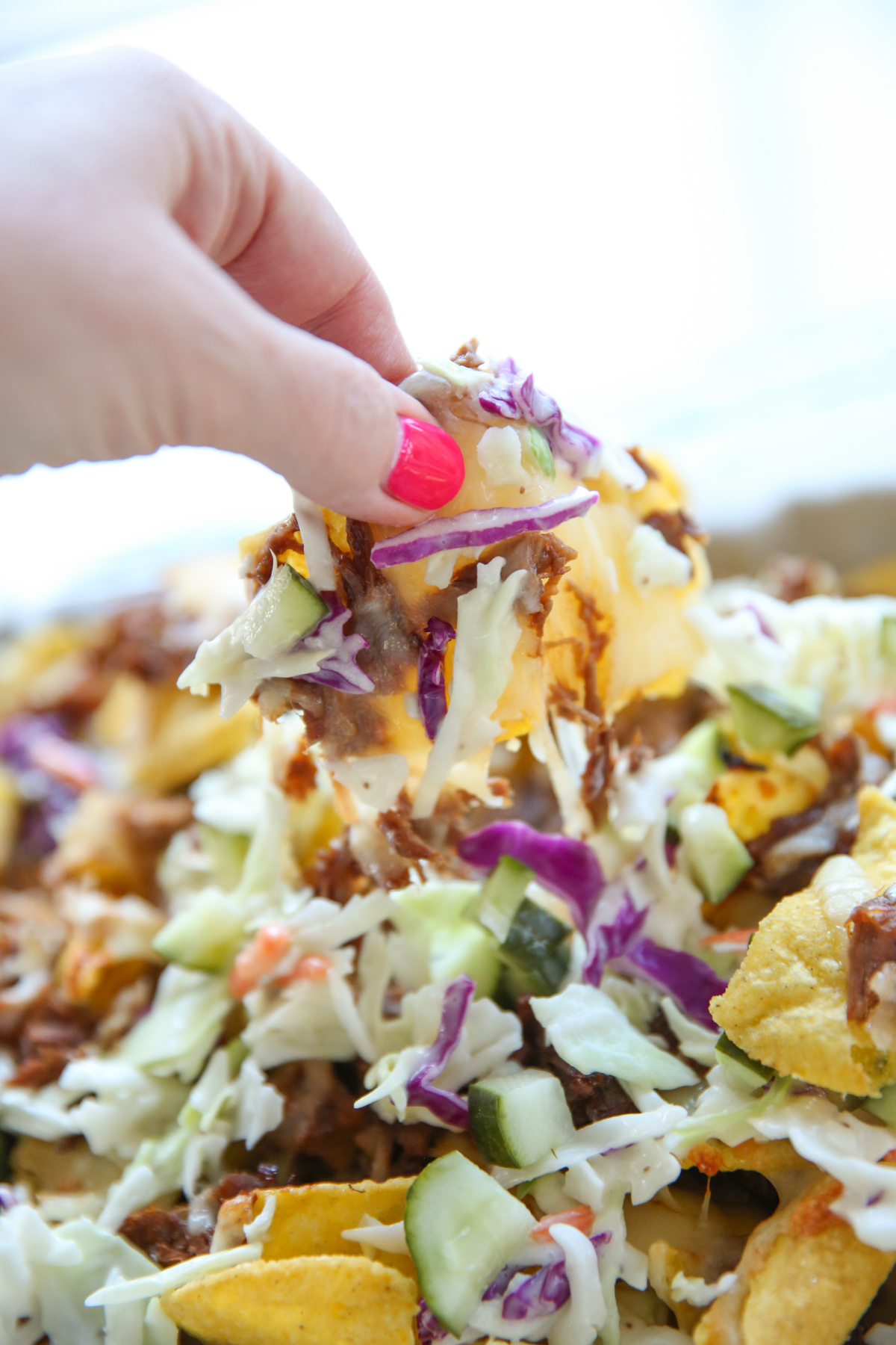 close up of tortilla chips on a sheet pan with cheese and pork
