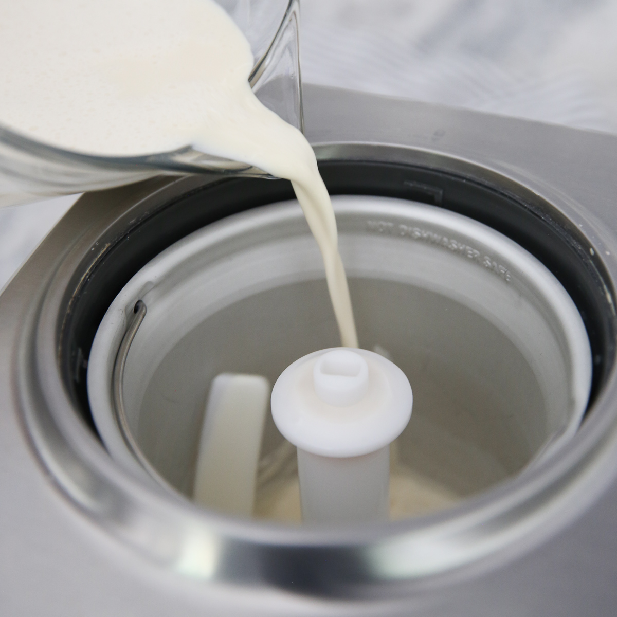 pouring vanilla ice cream into ice cream machine