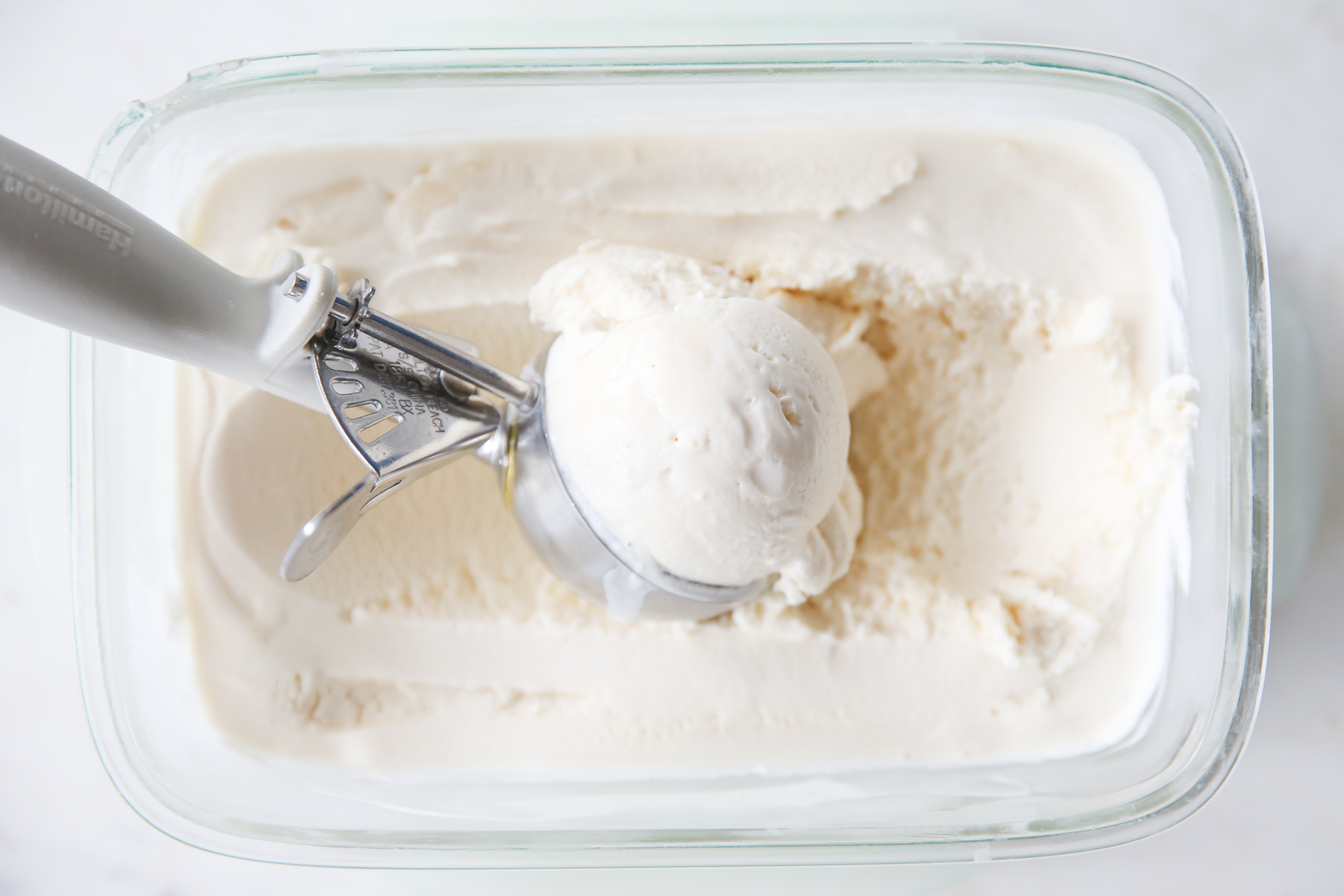 scooping up vanilla ice cream