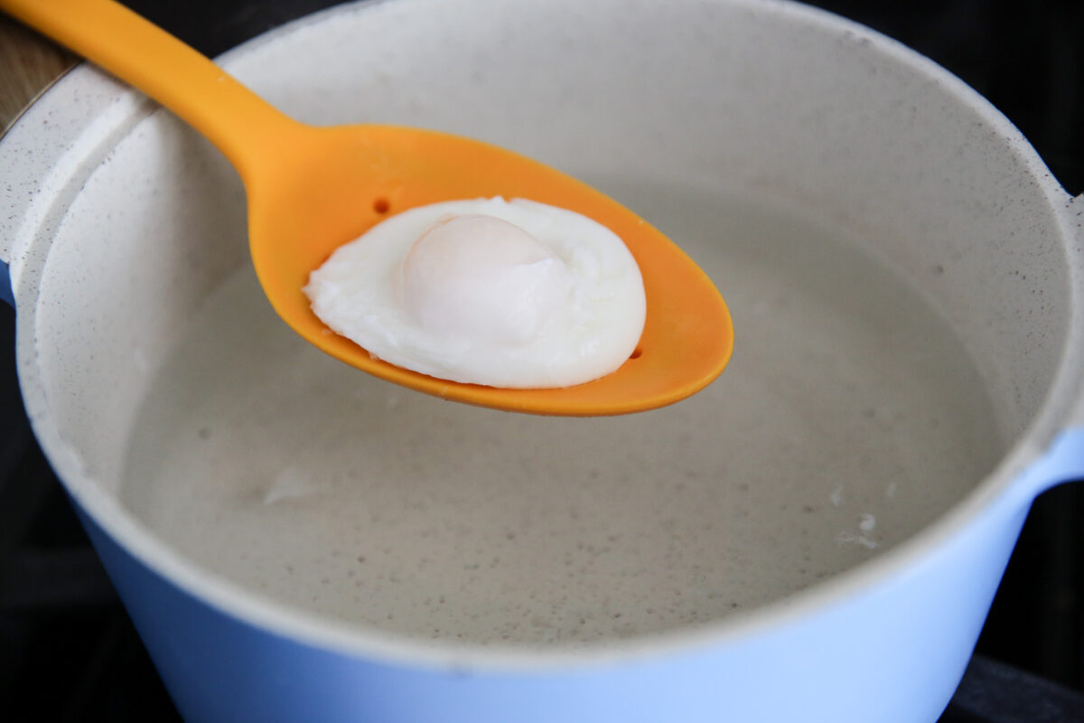 poached egg in a pot of simmering water