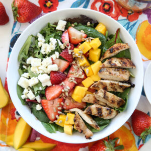 Strawberry and Mango salad plated on a white plate