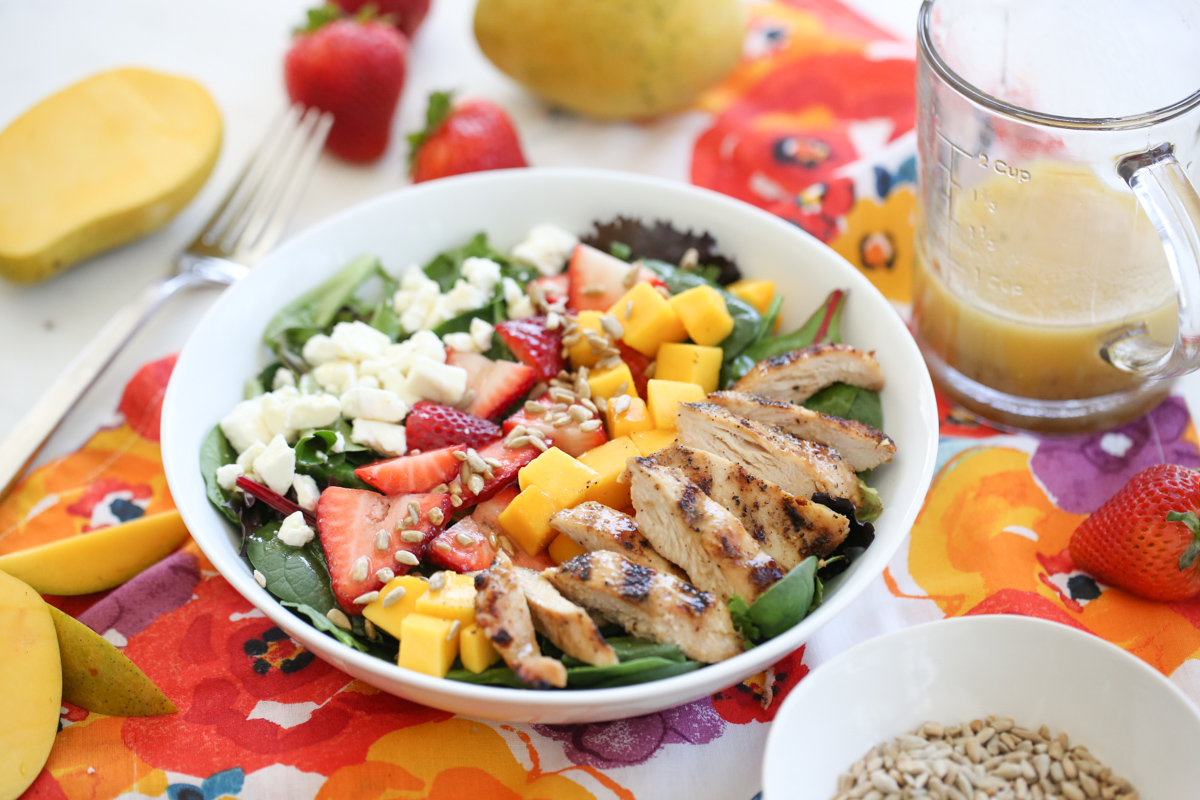 Strawberry Mango Salad in a white bowl on a colorful napkin