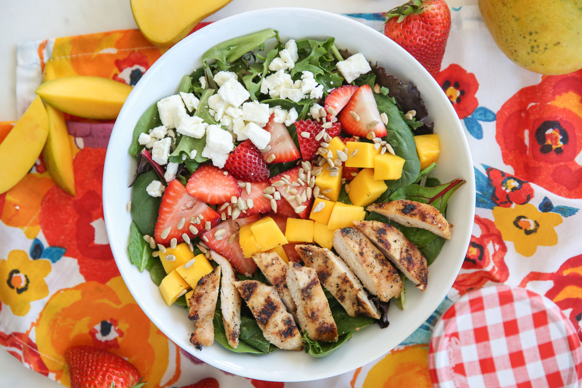 bowl of mango berry salad on a colorful napkin