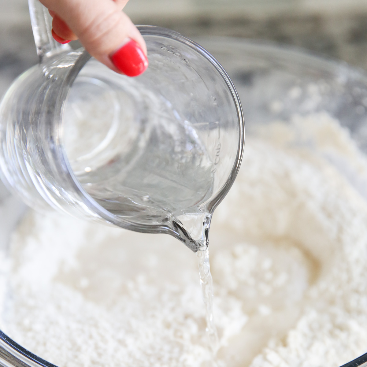 adding water to pizza dough